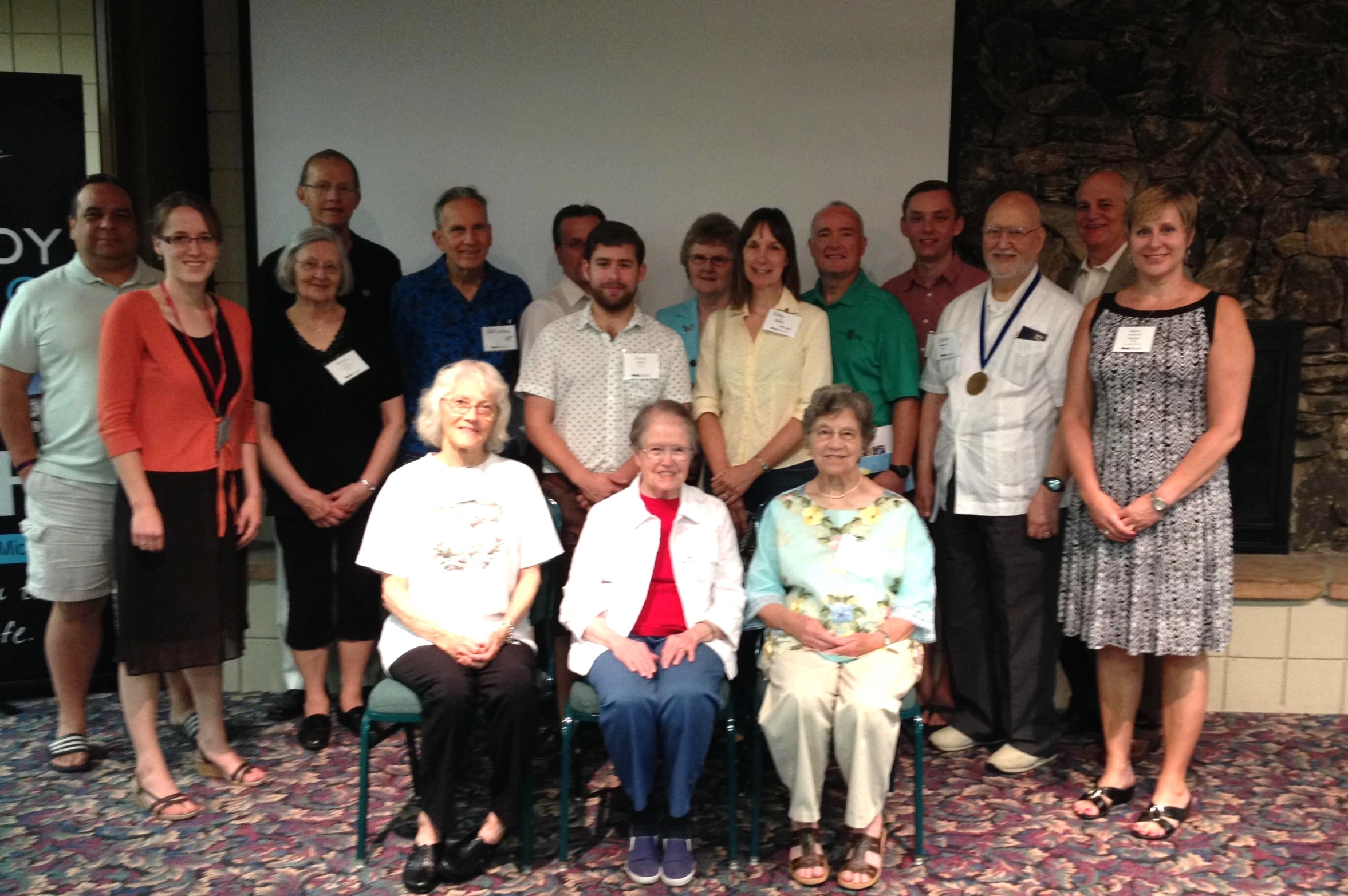 a group po taken of older people in a conference hall