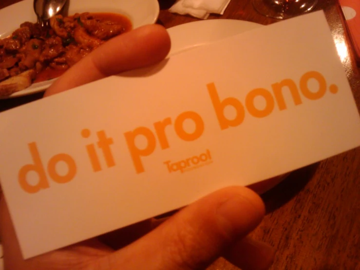 a person holds up a paper that says do it pro bong