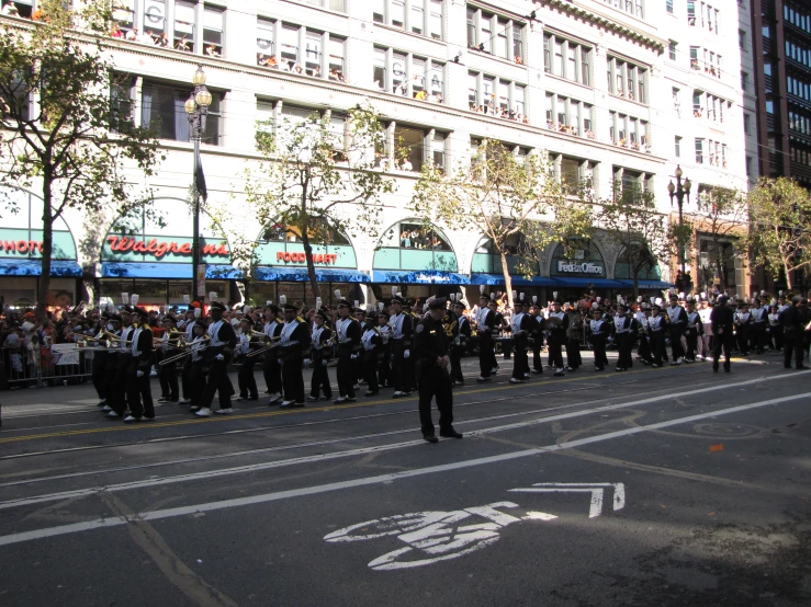 a line of men in police uniforms are standing near the street