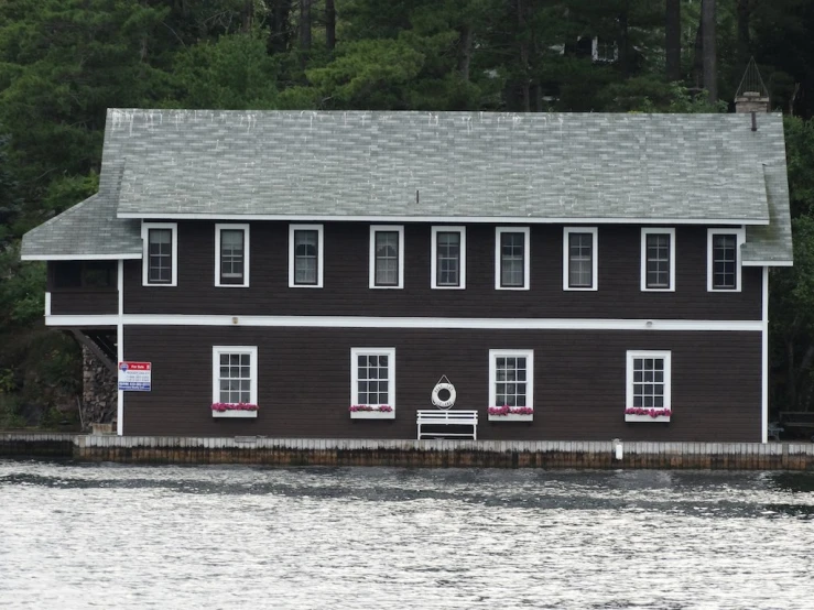 a black house with white shutters on the front of it