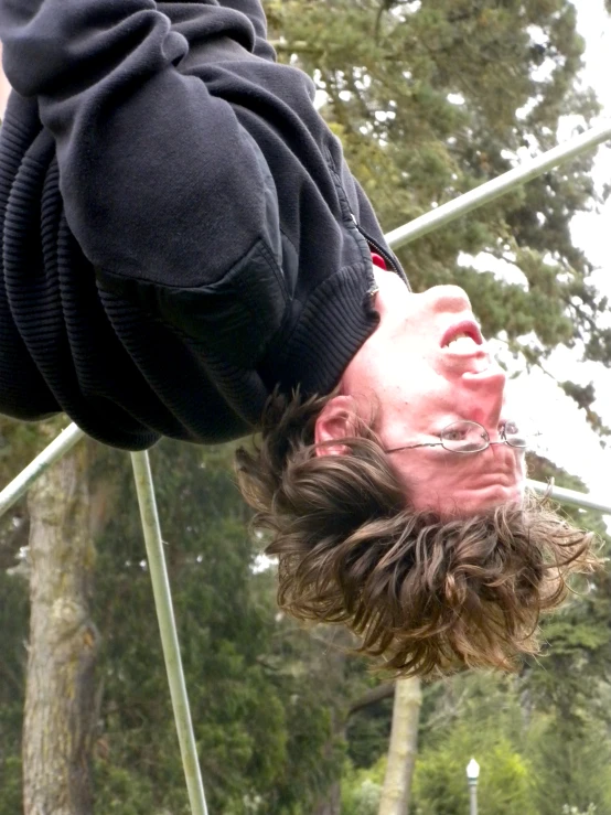 a man upside down with his hair down