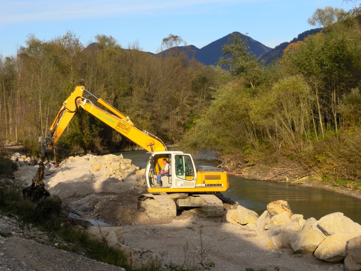 a construction worker with a machine is working on the land