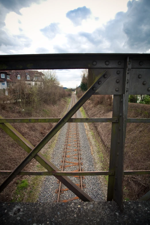 a view of train tracks through an overhang