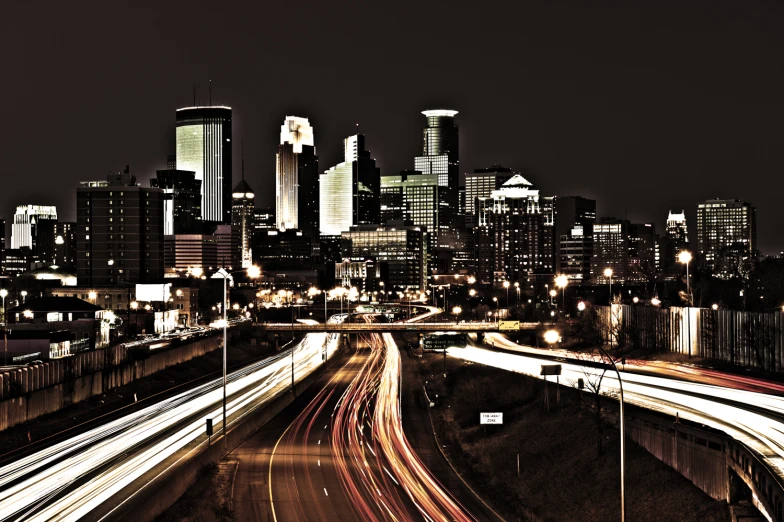 night view of a highway intersection with lights streaking up