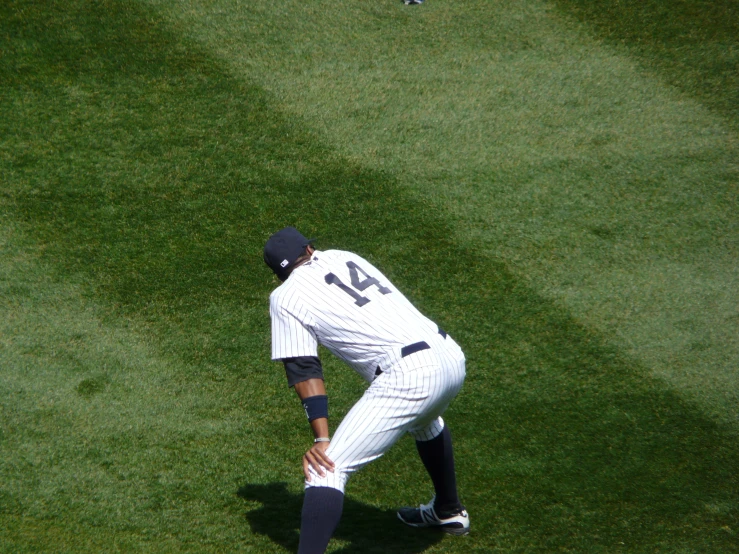 a baseball player squatting on the ground