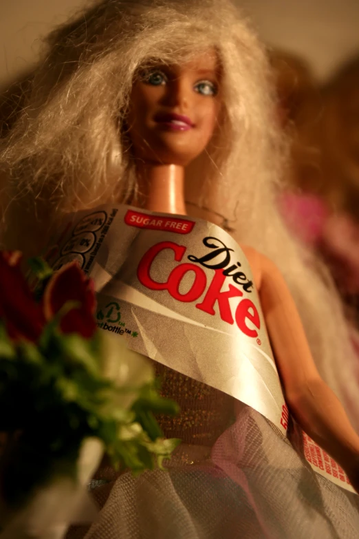 the barbie doll is wearing a coca cola robe