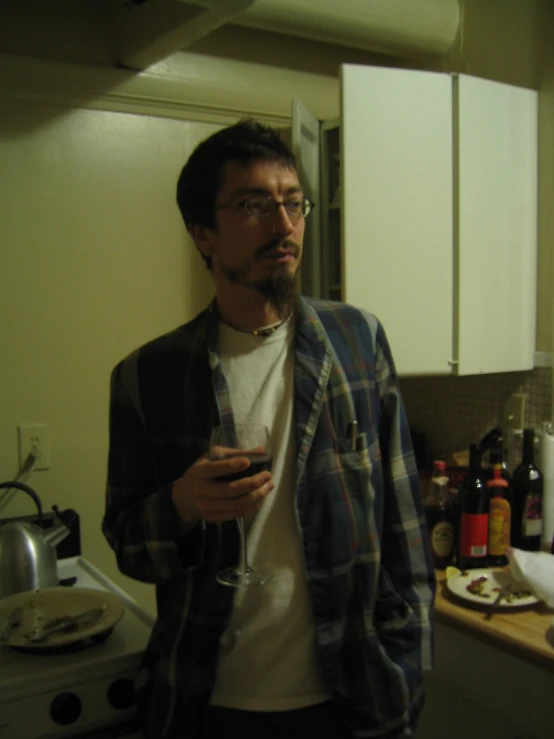 man in kitchen with glasses and drinks
