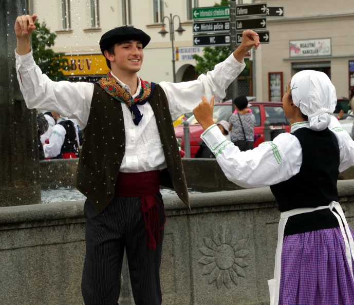 men and women dancing with each other outdoors in the rain