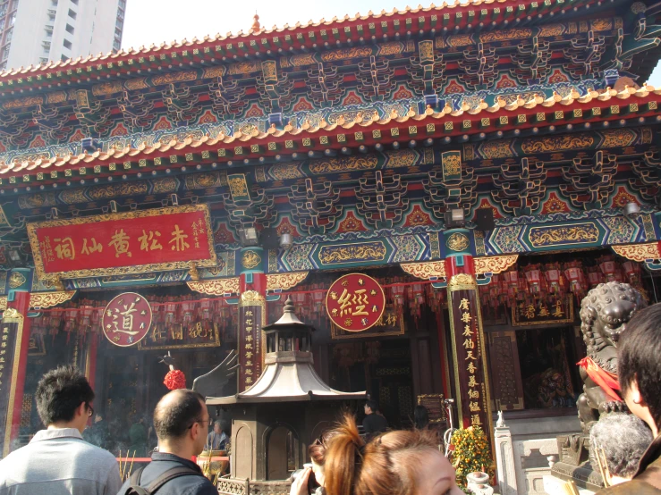 a man standing outside of a building with asian decorations