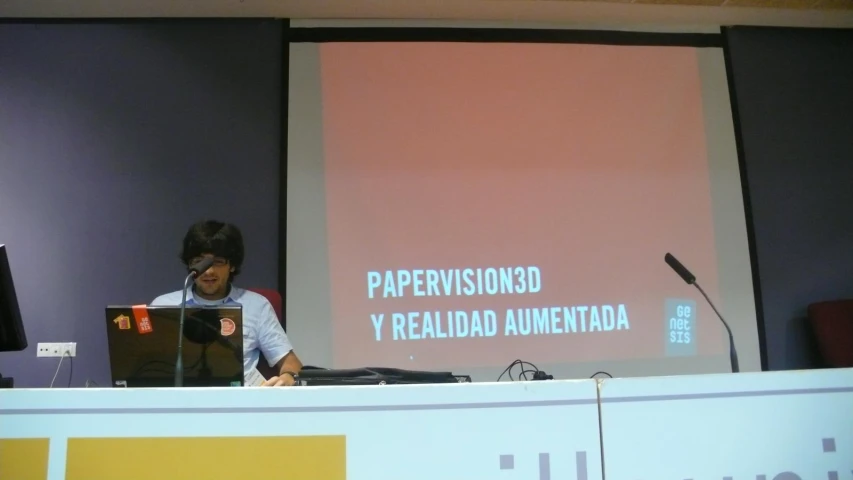 a man standing at a podium with a laptop