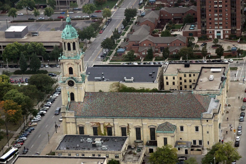 an aerial view of a large building with a clock on the top of it