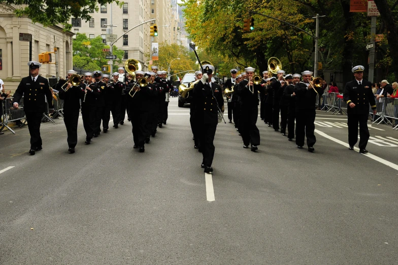 some people are marching down a street and some buildings