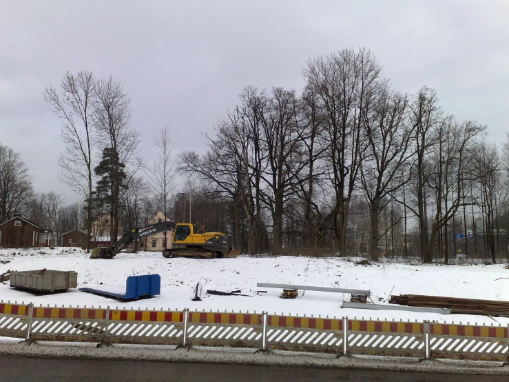 a construction site with some houses in the background