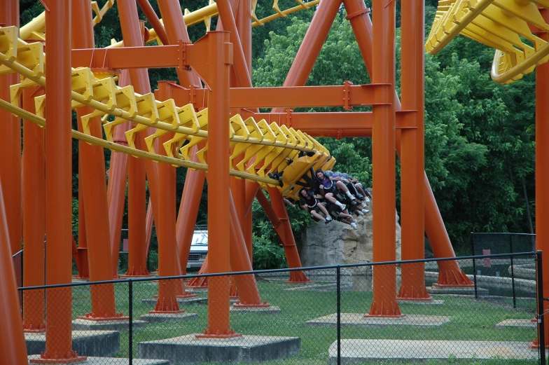 several people hanging out near a tall orange structure