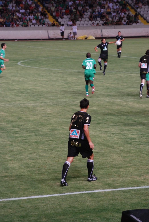 a soccer game with the players walking around