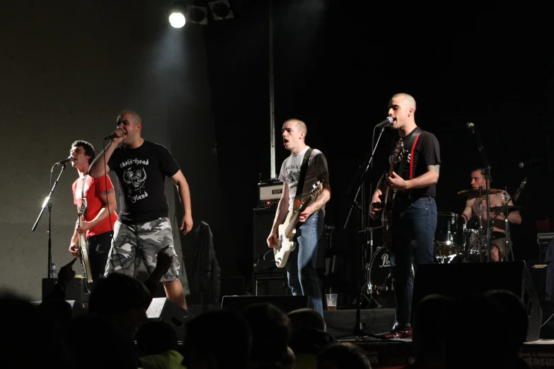 a group of people are playing on stage