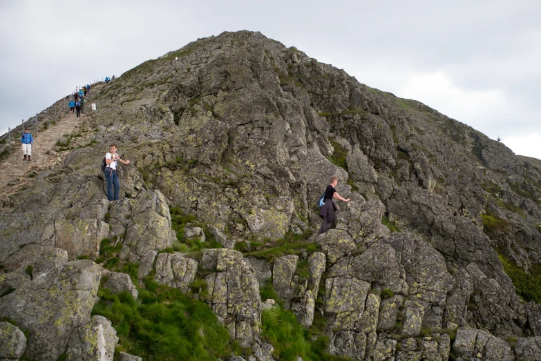 a group of people climbing up a rocky mountain