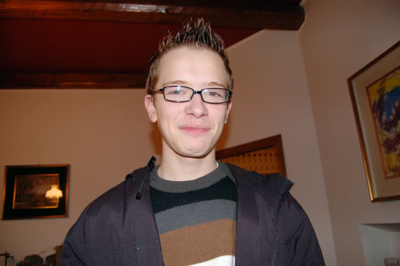 there is a young man in glasses posing for a picture