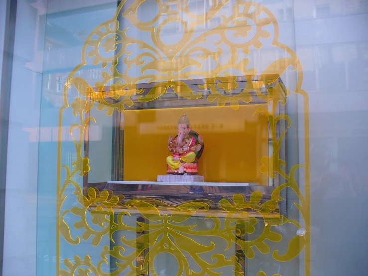 a yellow decorative piece of art and a window