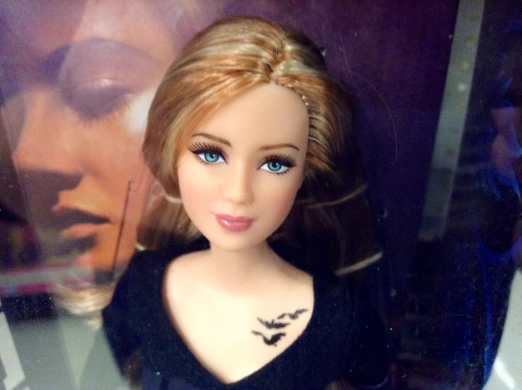 a young blond doll wearing black clothes and posing