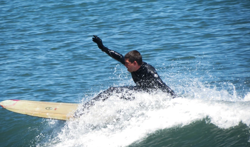man riding on the back of a surfboard in the ocean