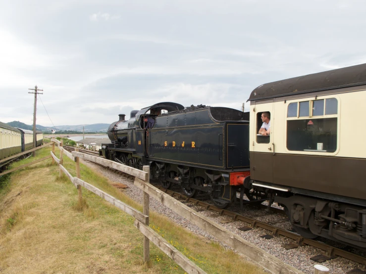 a train drives next to a rail yard