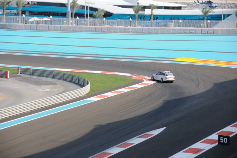 a police car driving on the track by the edge