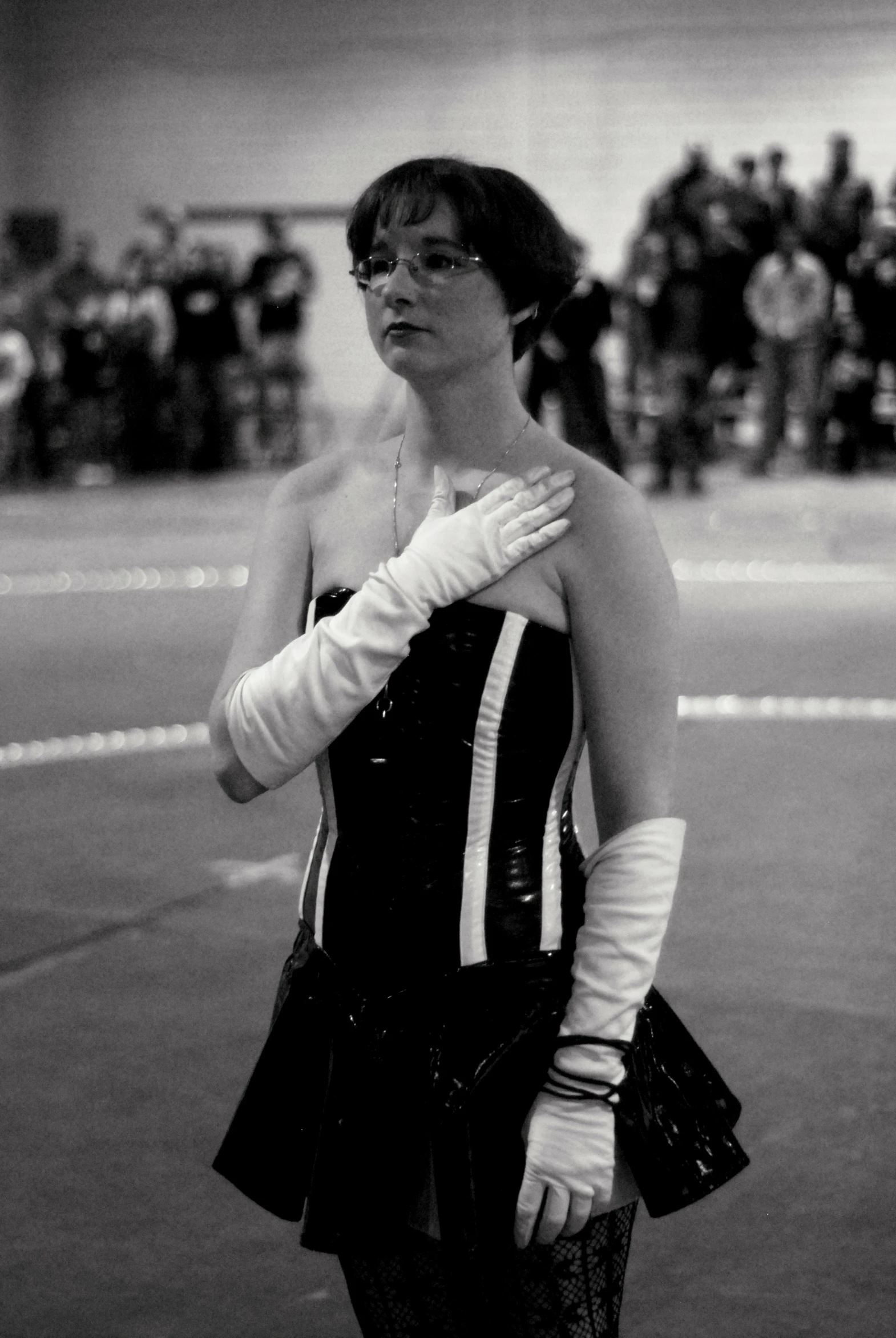 a woman standing on the side of a tennis court