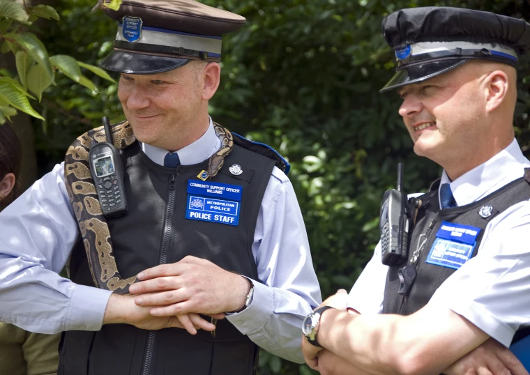 two police officers who are smiling and posing