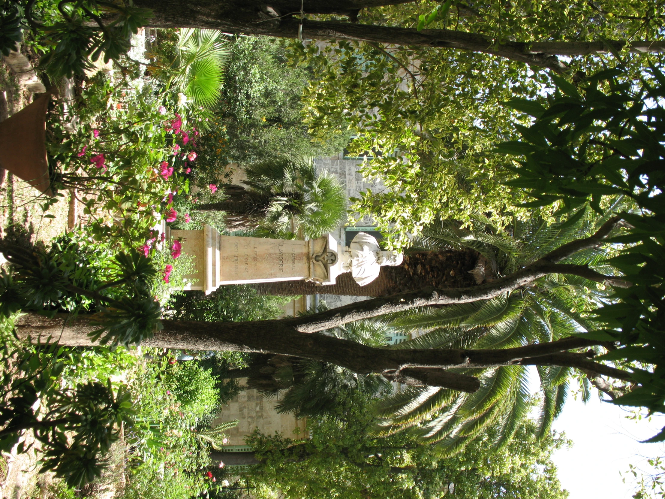 this park is full of plants and a statue