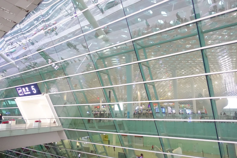 a person walking up an escalator next to a building