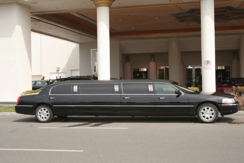 the funeral car is sitting in front of a building