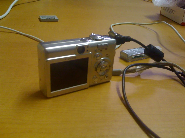 an old camera sitting on a wooden table