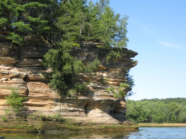 a scenic view of a cliff out in the water