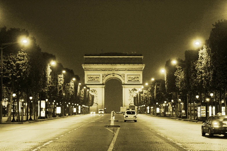 cars driving near the arc de triumph in france