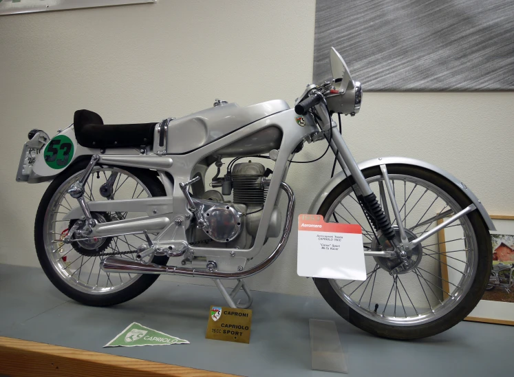 there is a motorcycle displayed in the museum