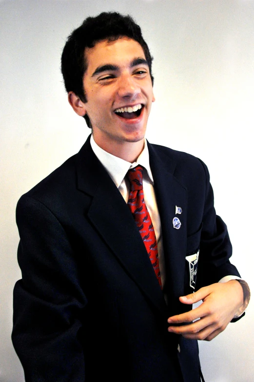 a man in a suit smiles and poses