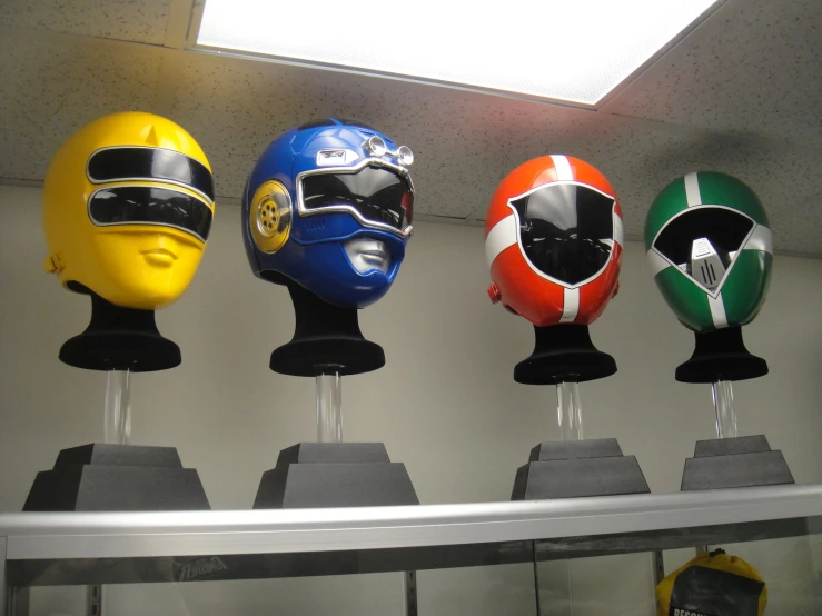 different types of helmets sit in front of a mirror