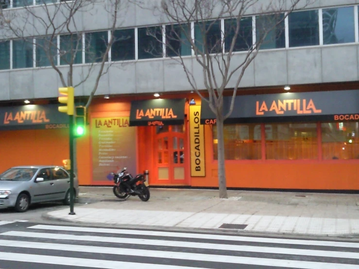 an orange building and car parked next to it