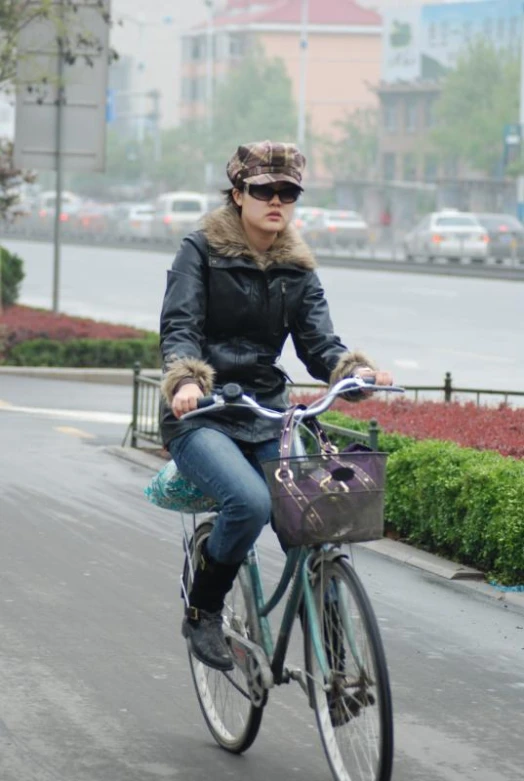 a person riding a bike on a city street