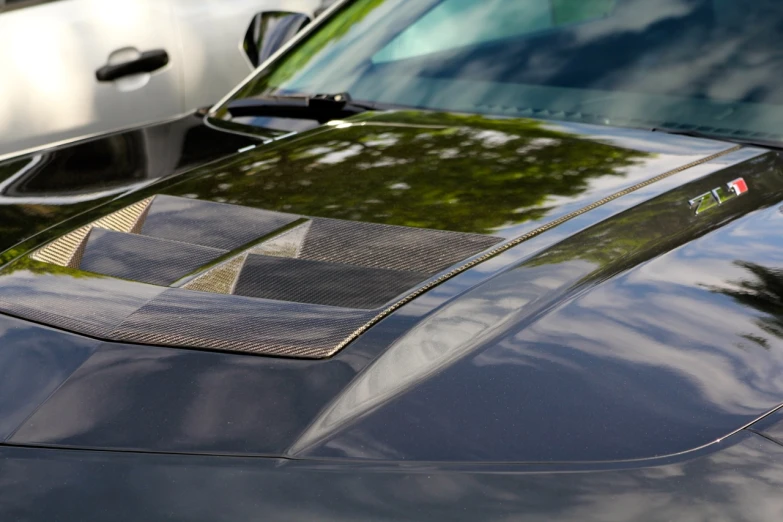 a close up of the front hood of a sports car