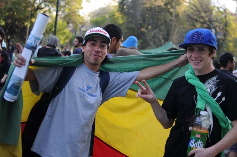 a man standing next to another man holding a flag