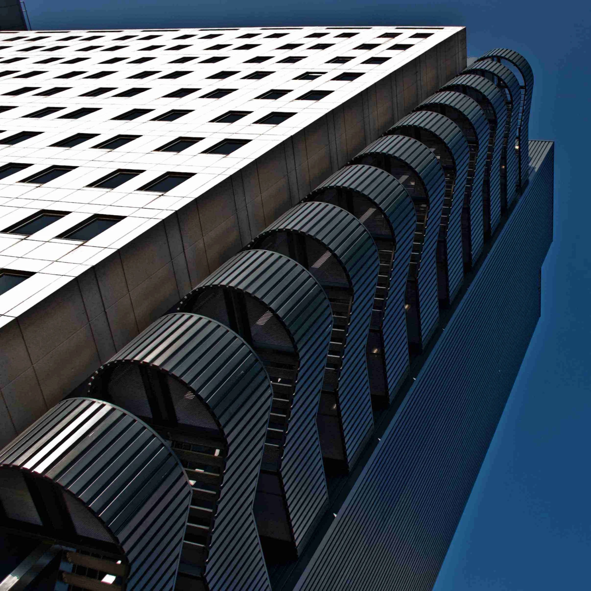 a white and black building with many black chairs on top of it