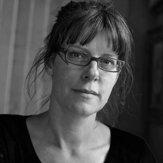 a woman is wearing glasses in a black and white po