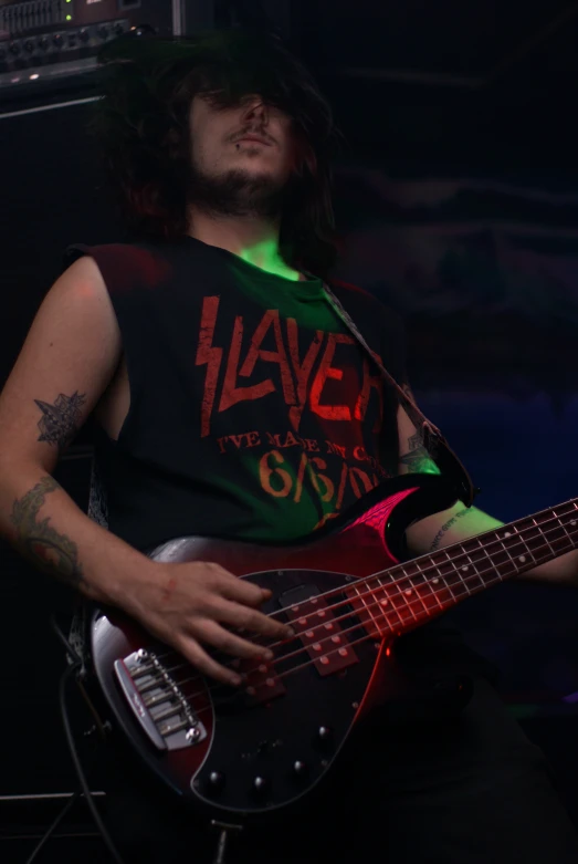 a man playing an electric guitar on stage