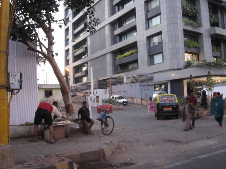 group of people walking on street next to building