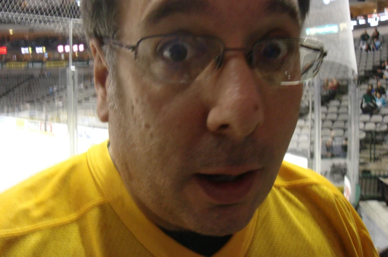 a close up of a person wearing glasses on a skating rink