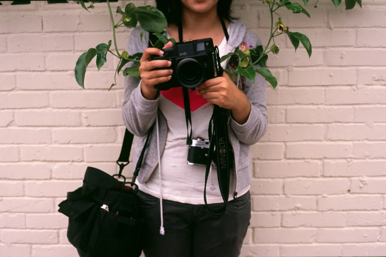 a woman holding up a camera and taking pictures