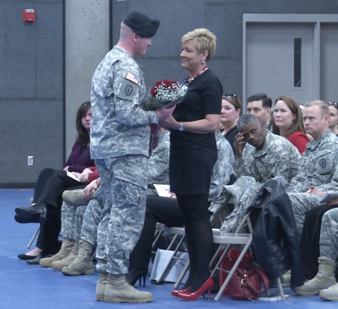 a soldier and a woman shaking hands