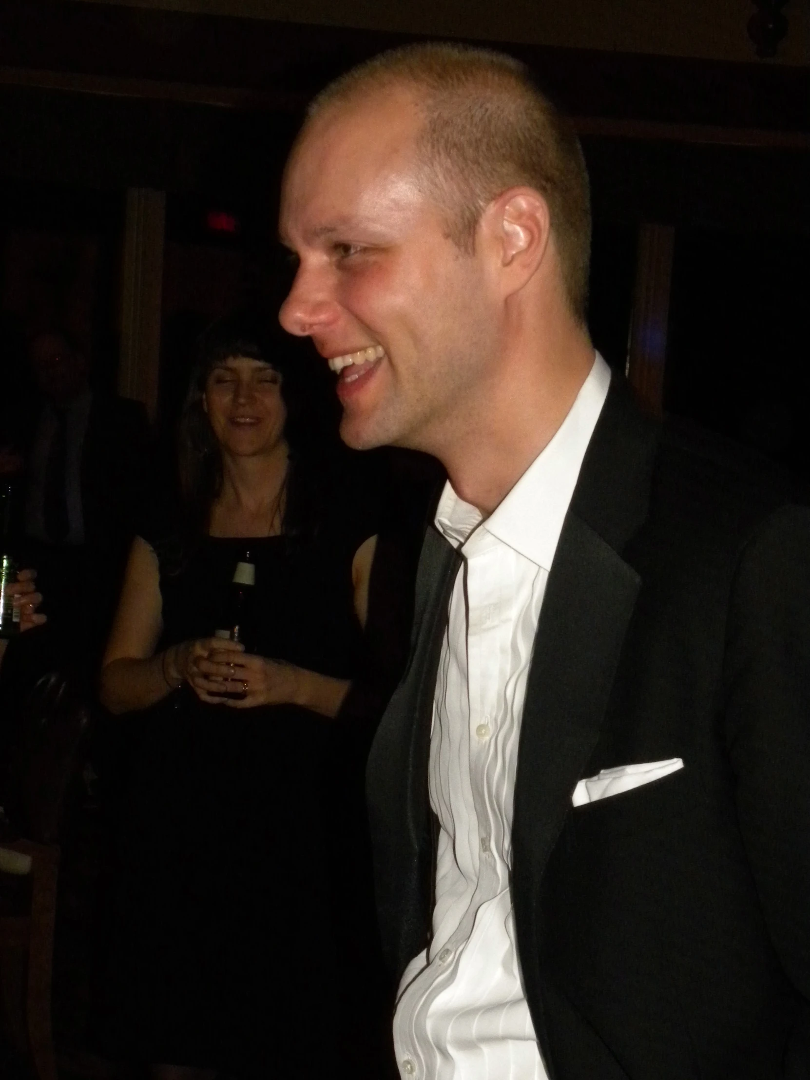 two smiling people with wine glasses in their hand